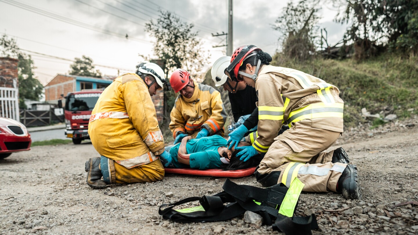 Firefighters helping a car accident victim