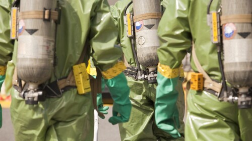 Rear view of HazMat firefighters with air tanks