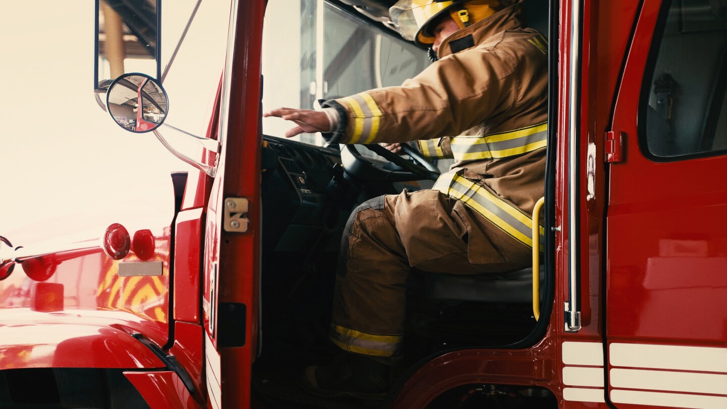 Firefighter about to close the door of his truck